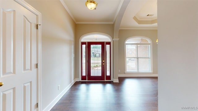entrance foyer featuring crown molding, baseboards, visible vents, and dark wood-type flooring