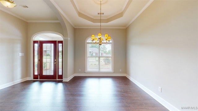 entrance foyer with arched walkways, a notable chandelier, visible vents, and dark wood-type flooring