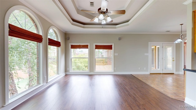 unfurnished room featuring ceiling fan, visible vents, crown molding, wood finished floors, and a tray ceiling