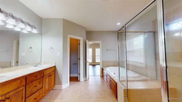 bathroom with a sink, double vanity, tile patterned floors, a garden tub, and a stall shower