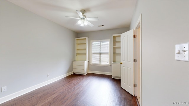 unfurnished bedroom featuring visible vents, baseboards, ceiling fan, and dark wood-style floors