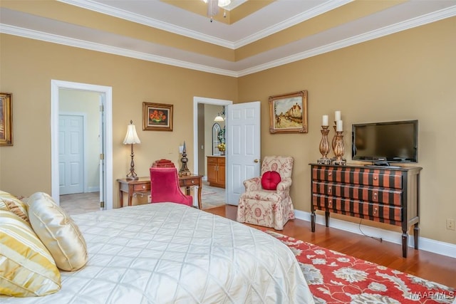 bedroom featuring baseboards, ornamental molding, and wood finished floors