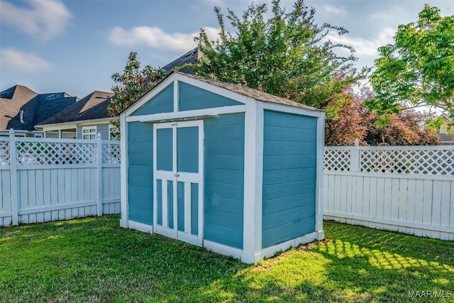 view of shed with a fenced backyard