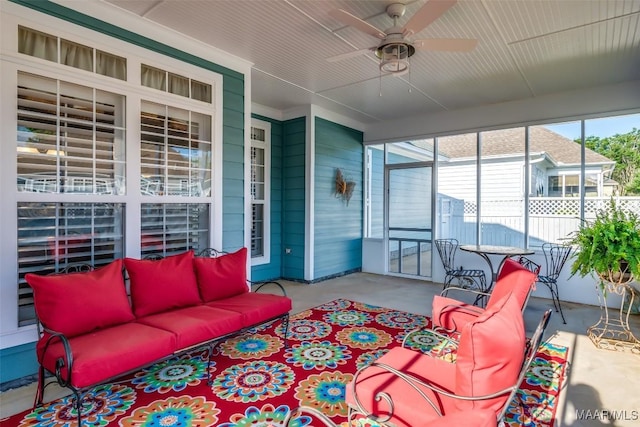 sunroom featuring a ceiling fan and outdoor lounge area