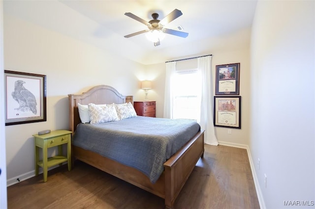 bedroom featuring baseboards, a ceiling fan, and wood finished floors