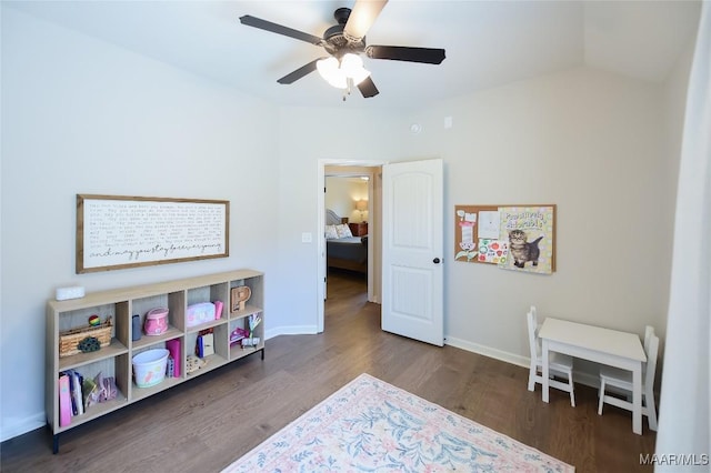 interior space featuring baseboards, a ceiling fan, and wood finished floors