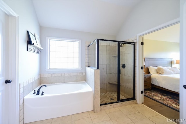 ensuite bathroom with lofted ceiling, a shower stall, ensuite bathroom, and a bath