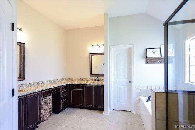 full bathroom featuring a sink, tile patterned flooring, double vanity, lofted ceiling, and a bath