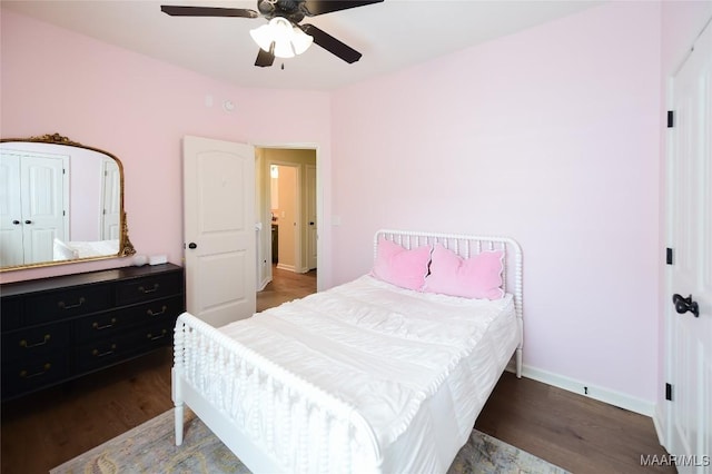 bedroom featuring baseboards, a ceiling fan, and wood finished floors