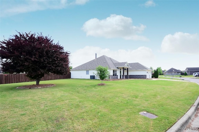 view of front of home featuring central air condition unit, a front lawn, and fence