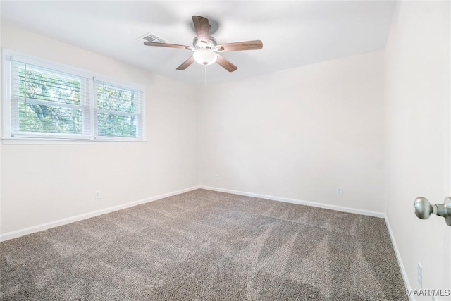 spare room featuring carpet floors, a ceiling fan, baseboards, and visible vents