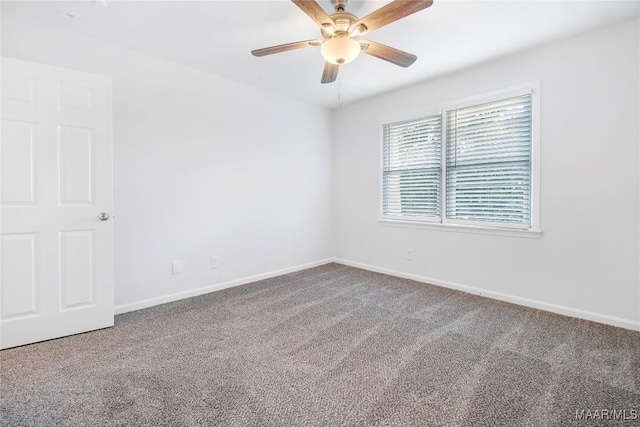spare room featuring baseboards, carpet flooring, and ceiling fan
