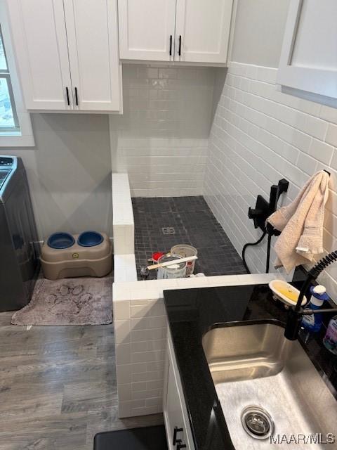 169 Foxfire Ct, Wetumpka, AL 36092 - kitchen with a sink, white cabinetry, wood finished floors, and washer / dryer