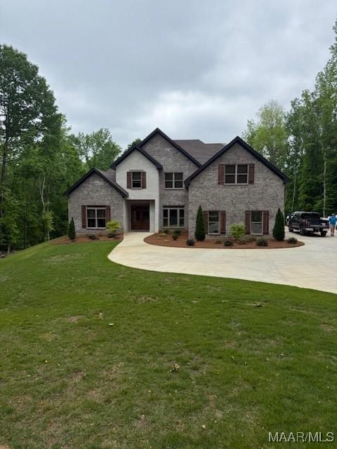 169 Foxfire Ct, Wetumpka, AL 36092 - view of front facade with curved driveway, a front yard, and stone siding