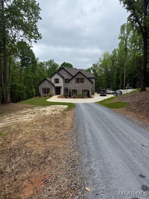 169 Foxfire Ct, Wetumpka, AL 36092 - view of front facade featuring curved driveway and stone siding