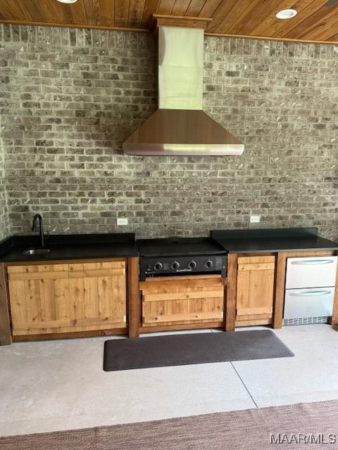 169 Foxfire Ct, Wetumpka, AL 36092 - kitchen featuring dark countertops, wall chimney exhaust hood, wood ceiling, a sink, and cooktop