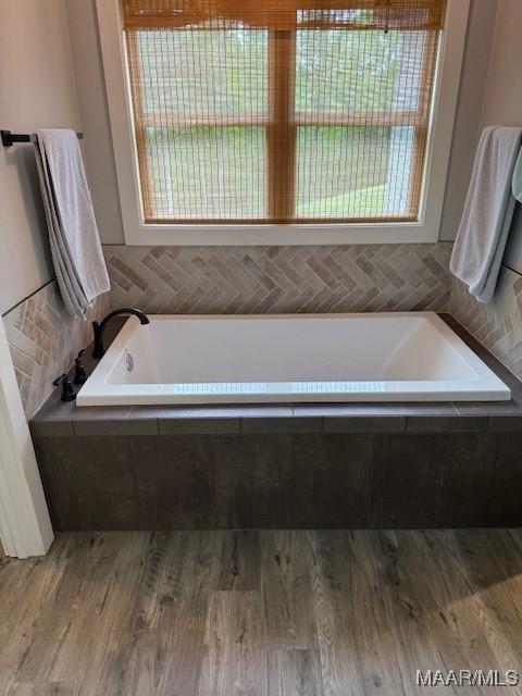 169 Foxfire Ct, Wetumpka, AL 36092 - bathroom with a garden tub and wood finished floors
