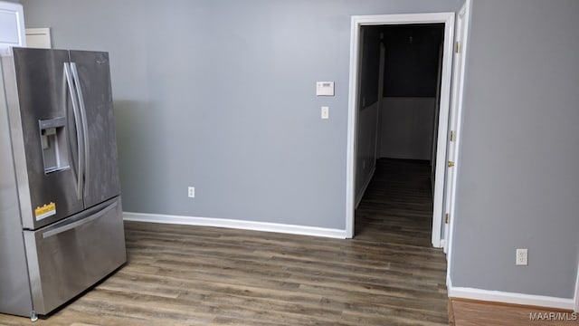 kitchen with baseboards, stainless steel fridge, and wood finished floors
