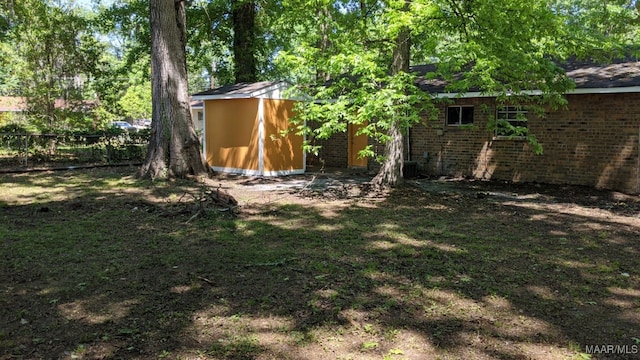 view of yard featuring central air condition unit and fence