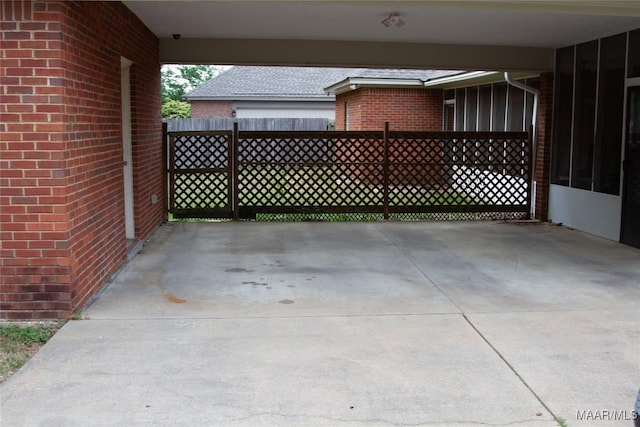 view of patio / terrace with fence and a carport
