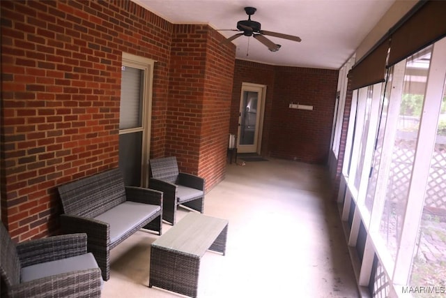 unfurnished sunroom with ceiling fan