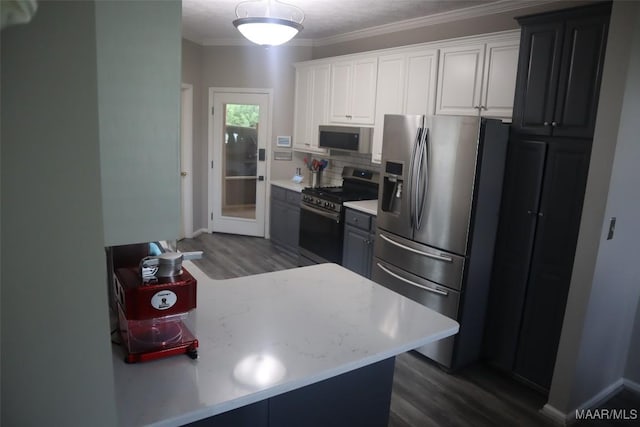 kitchen with light countertops, backsplash, dark wood-style floors, and stainless steel appliances