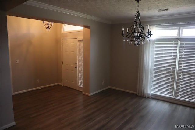unfurnished dining area featuring ornamental molding, wood finished floors, and a chandelier