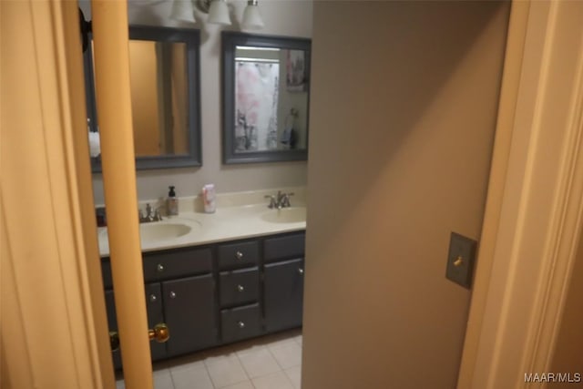 full bath with a sink, tile patterned flooring, and double vanity