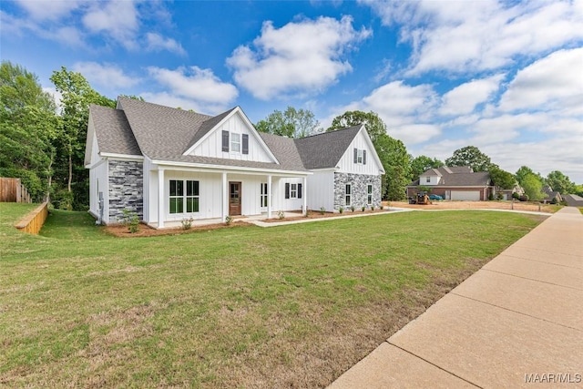 modern farmhouse style home with board and batten siding, roof with shingles, covered porch, and a front yard