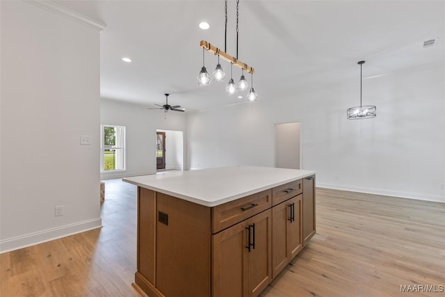 kitchen featuring visible vents, pendant lighting, light wood finished floors, and ceiling fan