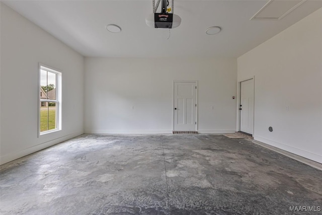 garage with baseboards and a garage door opener