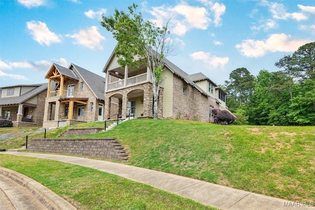 105 Bell Pkwy, Wetumpka, AL 36092 - view of front of property featuring a front yard, a balcony, and stone siding