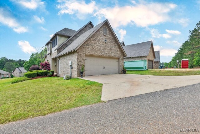 105 Bell Pkwy, Wetumpka, AL 36092 - traditional home with a front yard, a garage, brick siding, concrete driveway, and a shingled roof
