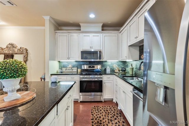 105 Bell Pkwy, Wetumpka, AL 36092 - kitchen featuring crown molding, visible vents, dark wood-type flooring, a sink, and appliances with stainless steel finishes