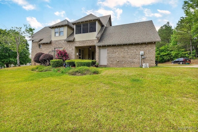 105 Bell Pkwy, Wetumpka, AL 36092 - view of front of house with brick siding, a shingled roof, and a front yard