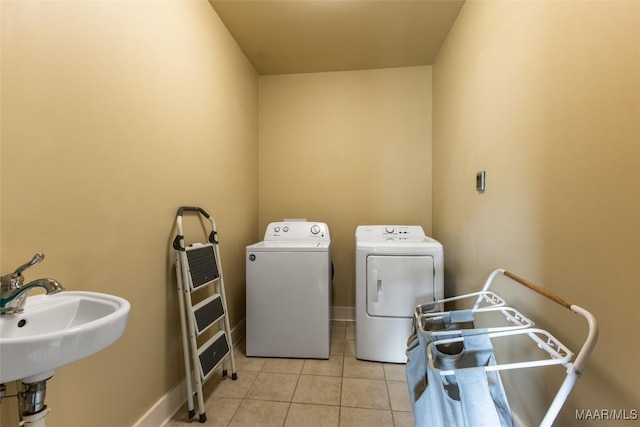 105 Bell Pkwy, Wetumpka, AL 36092 - laundry room featuring laundry area, baseboards, separate washer and dryer, a sink, and light tile patterned floors