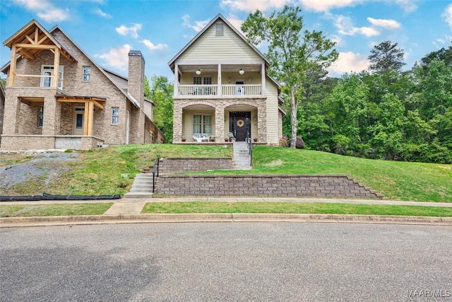 105 Bell Pkwy, Wetumpka, AL 36092 - view of front of house with a balcony, a front yard, a chimney, brick siding, and a porch