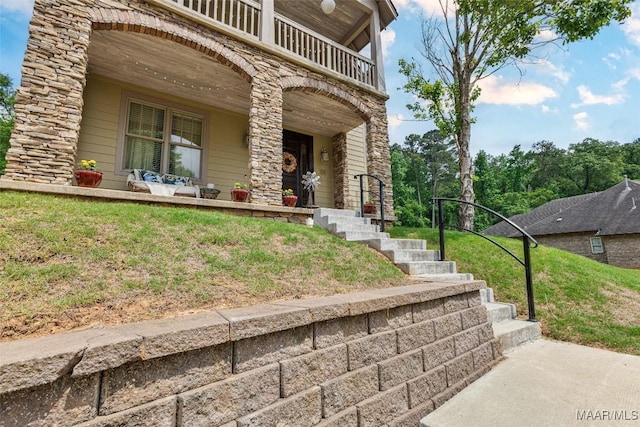 105 Bell Pkwy, Wetumpka, AL 36092 - doorway to property featuring a lawn, stone siding, a porch, and a balcony