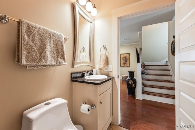 105 Bell Pkwy, Wetumpka, AL 36092 - bathroom featuring vanity, ornamental molding, toilet, and wood finished floors