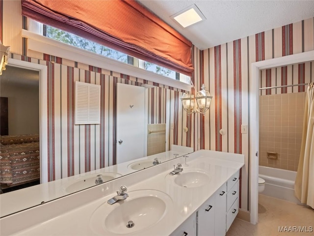 bathroom featuring toilet, plenty of natural light, and a sink