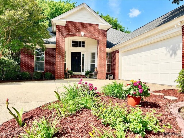 7731 Steele Ridge Dr, Montgomery, AL 36117 - traditional-style house featuring brick siding, roof with shingles, driveway, and an attached garage