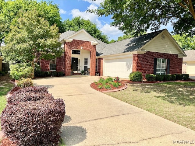 view of front of home with an attached garage, concrete driveway, a front lawn, and brick siding