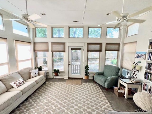 sunroom / solarium featuring a healthy amount of sunlight, a high ceiling, and recessed lighting