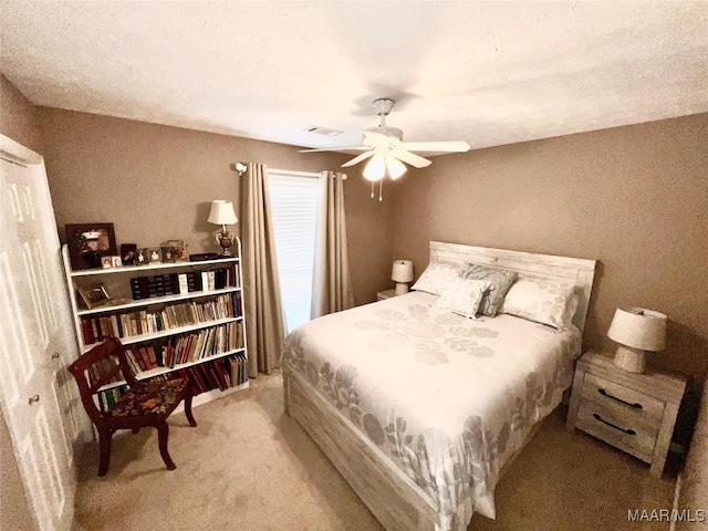 bedroom with carpet flooring, ceiling fan, and visible vents