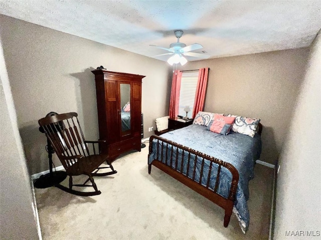 bedroom with baseboards, ceiling fan, and light colored carpet