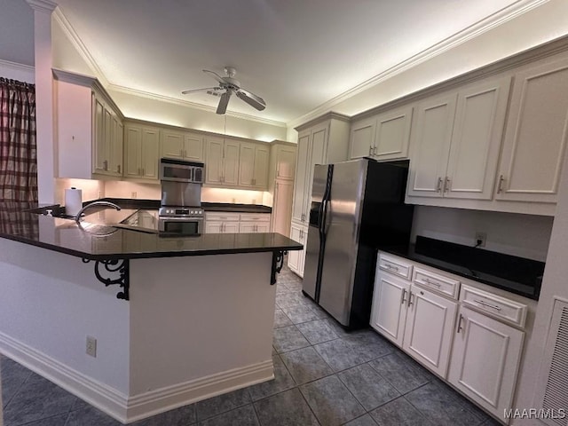 kitchen featuring crown molding, appliances with stainless steel finishes, dark countertops, and ceiling fan