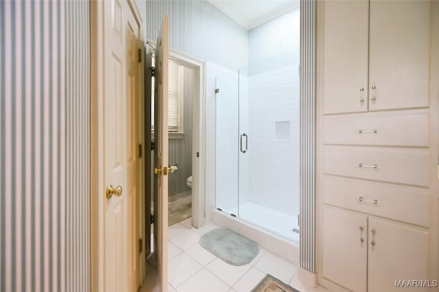 full bath with tile patterned flooring, a stall shower, and toilet
