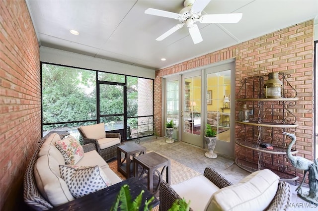 sunroom / solarium with an outdoor living space and a ceiling fan