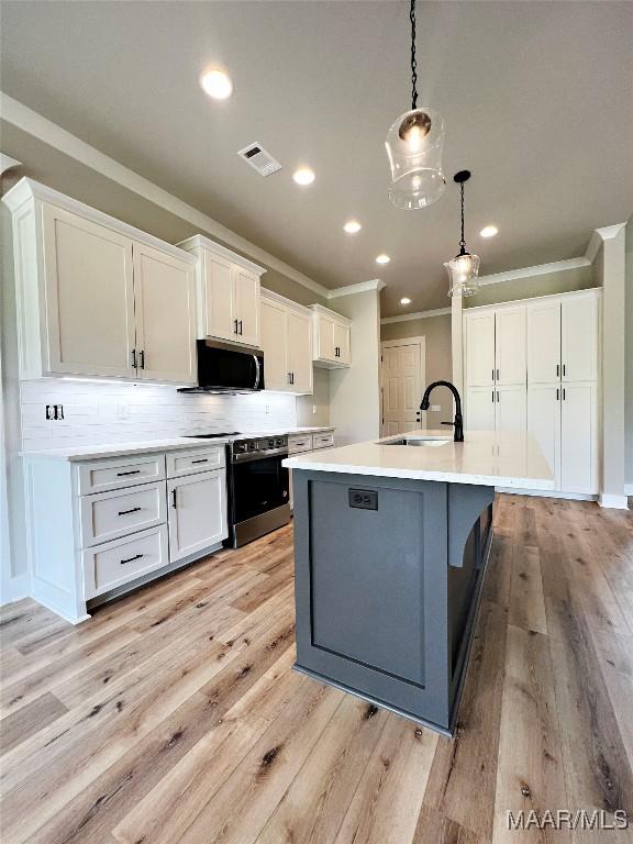 171 Mountain Laurel Rdg, Wetumpka, AL 36093 - kitchen featuring a sink, appliances with stainless steel finishes, ornamental molding, white cabinets, and decorative backsplash