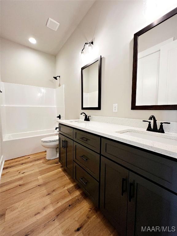 171 Mountain Laurel Rdg, Wetumpka, AL 36093 - full bathroom with double vanity, toilet, wood finished floors, and  shower combination